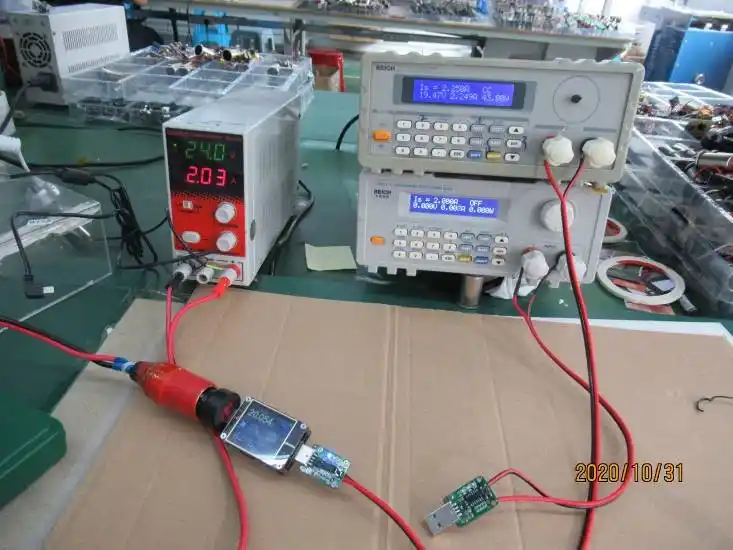 Car charger E-Mark certification lab testing with oscilloscope and electronic load at WOWOHCOOL Shenzhen QC laboratory